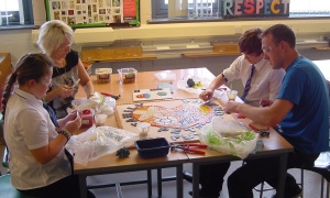 Parents & children creating the British Heart Foundation school mosaic at Endeavour High School, Hull