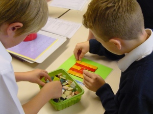 Children of Ackton Pastures School creating their own mini mosaic
